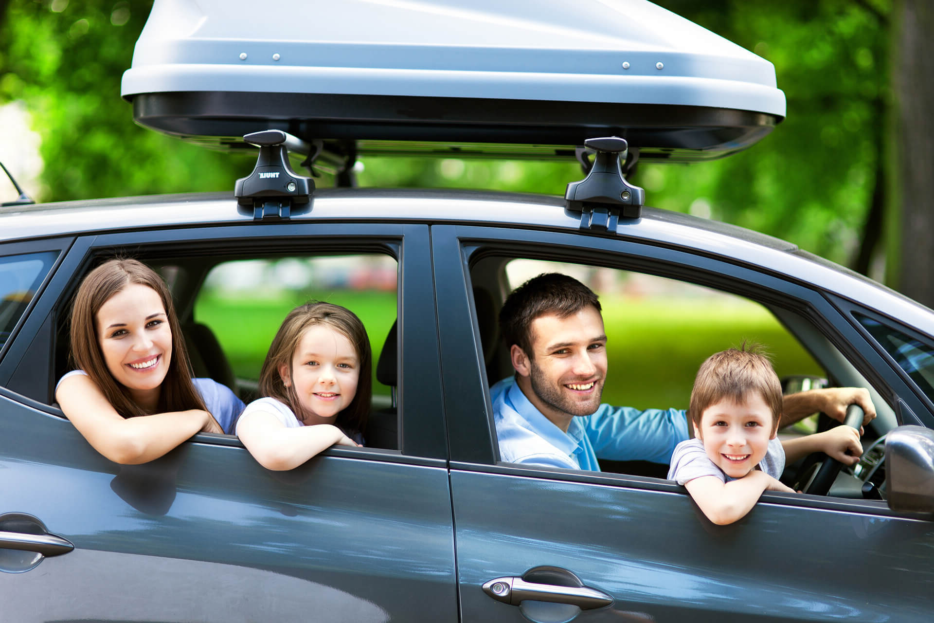 Family posing inside their car